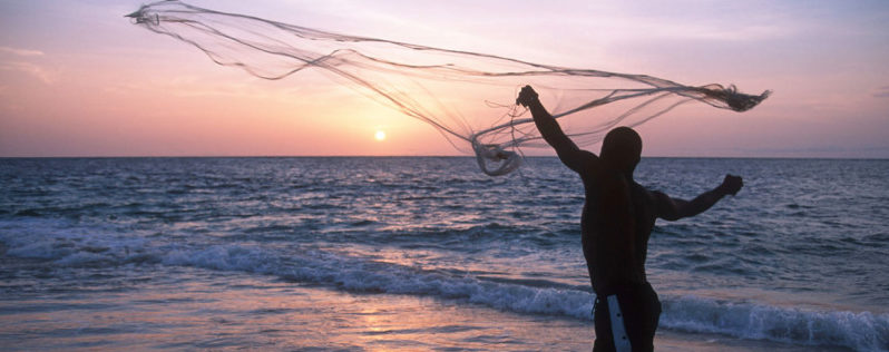 A fisherman casts his net on the coast at sunset Gabon ©Martin Harvey / WWF